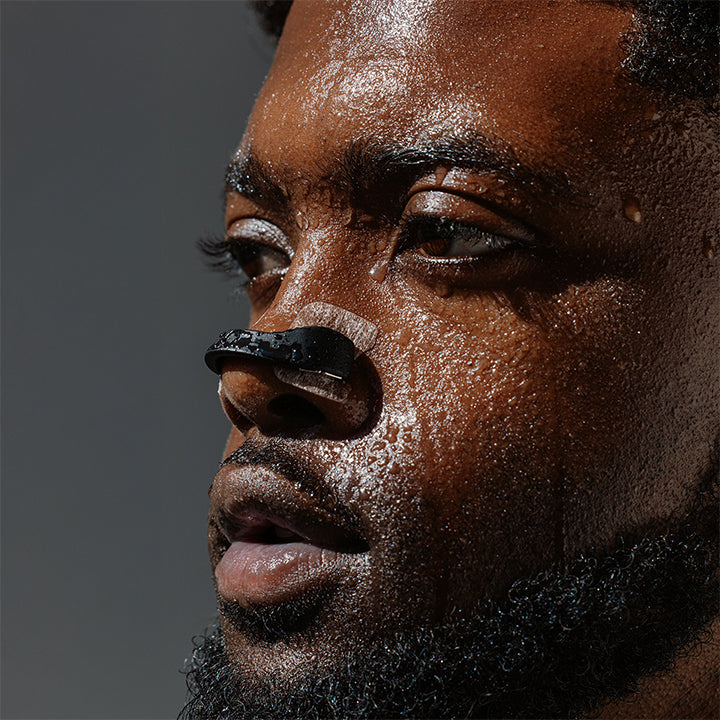 Athlete mid-workout wearing Intake, tabs holding through sweat